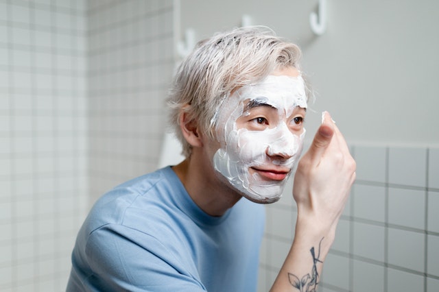 Guys washing his face